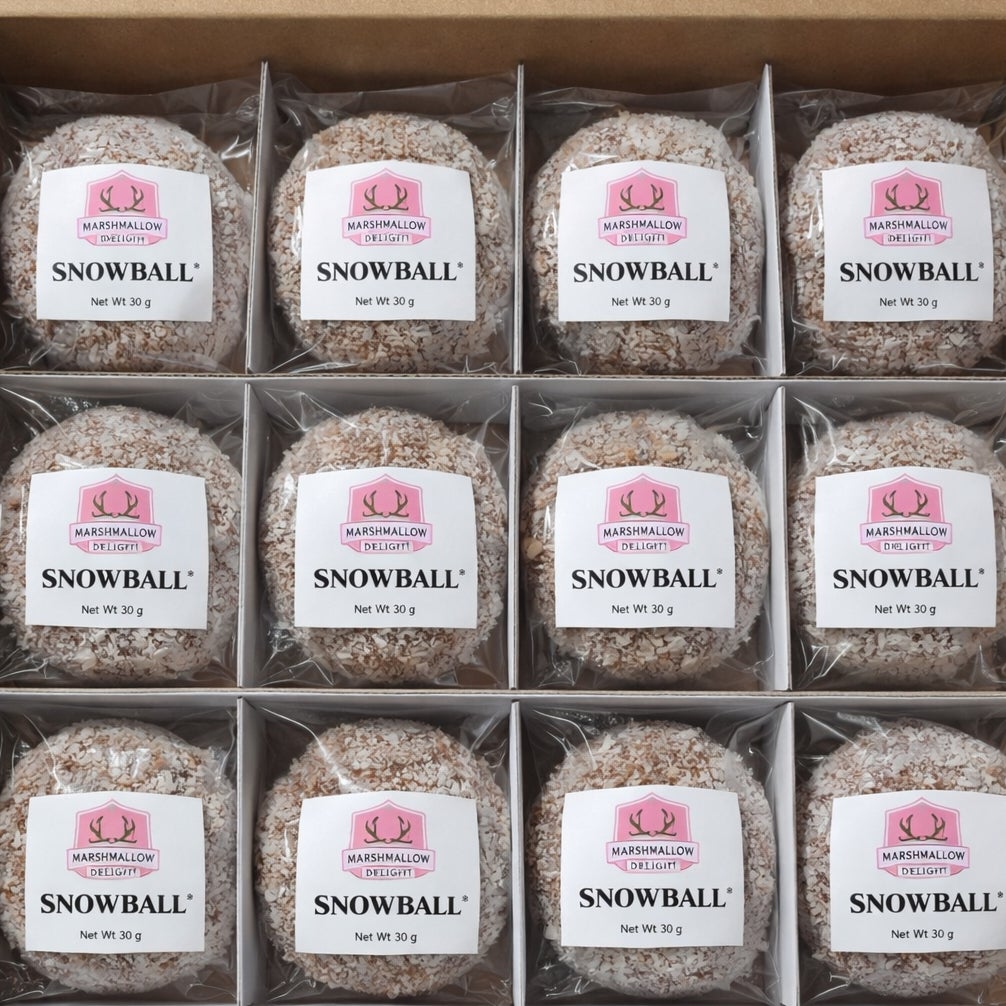 Twelve individually wrapped Scottish Snowballs arranged in a presentation box